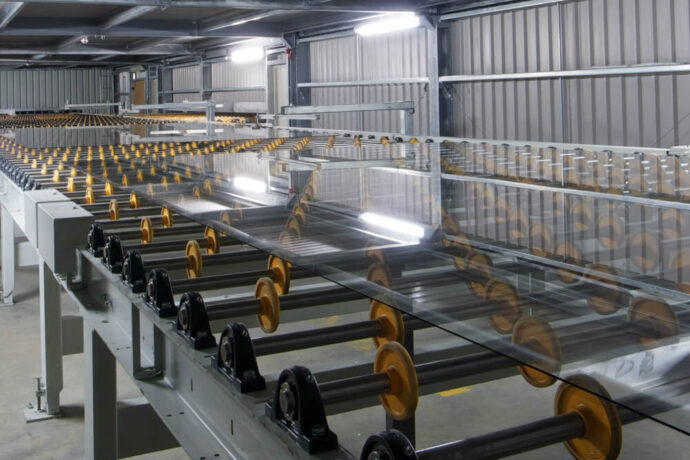 Glass sheets on a rollers in a warehouse