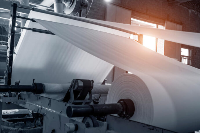 Photo of a paper web being rolled in a factory